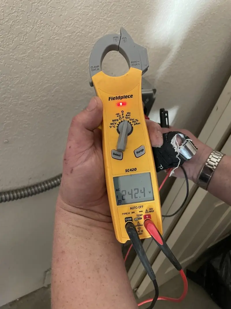 Voltage testing with clamp meter during Outlet Installation in Cape St. Claire